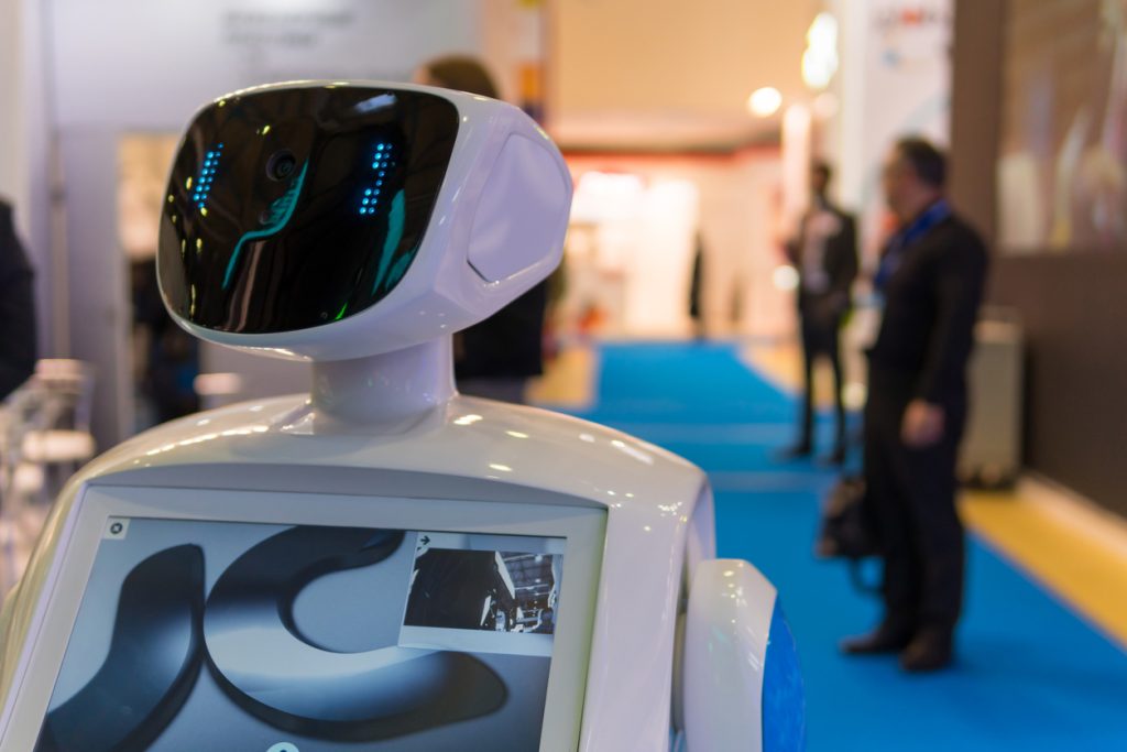 A robot provide assistance to attendees at a professional conference