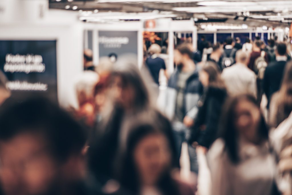 Image of conference attendees in an exhibit hall