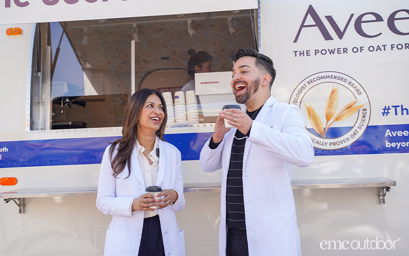 Aveeno airstream with two doctor influencers standing in front of the airstream