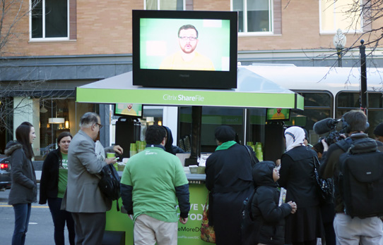 Image of conumsers engaging with outdoor advertising display