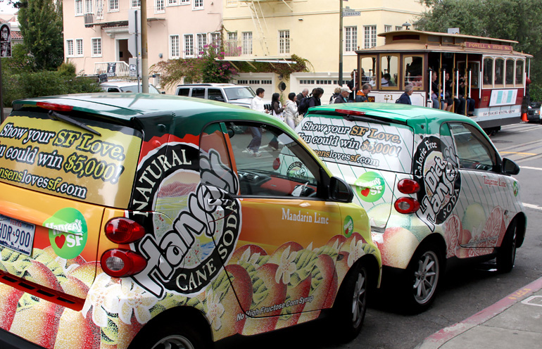 Image of wrapped vehicles in San Francisco used by a beverage company to reach consumers