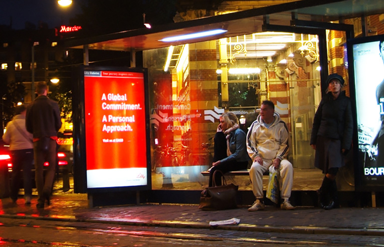 Image of transit shelter advertising in Europe being used to reach event attendees